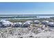 Aerial view shows white condos with a community pool surrounded by beach and bay on a sunny day at 7470 Palm Island Dr # 2813, Placida, FL 33946