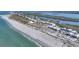 Aerial view features beachfront condos along a coastline with beach, bay and lush greenery at 7470 Palm Island Dr # 2813, Placida, FL 33946