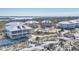 Aerial view showcasing multiple white condos with screened porches and a community pool near the water at 7470 Palm Island Dr # 2813, Placida, FL 33946