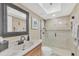 Updated bathroom featuring a glass shower, decorative mirror, and a sleek, modern vanity at 7470 Palm Island Dr # 2813, Placida, FL 33946