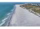 Expansive beach view showcasing the beautiful coastline with gentle waves rolling onto the shore at 7470 Palm Island Dr # 2813, Placida, FL 33946