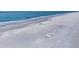 Gorgeous view of a sandy beach with a relaxing lounge chair, inviting vacation vibes at 7470 Palm Island Dr # 2813, Placida, FL 33946