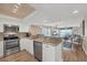 Modern kitchen open to the living area showcasing granite countertops and stainless steel appliances at 7470 Palm Island Dr # 2813, Placida, FL 33946