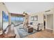 This cozy living room offers a seating area, accent rug, and sliding doors with stunning ocean views at 7470 Palm Island Dr # 2813, Placida, FL 33946