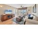 Living room with ceiling fan, hardwood floors, area rug, and ocean views through the screened porch at 7470 Palm Island Dr # 2813, Placida, FL 33946