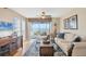Bright living room featuring beach views from screened porch, ceiling fan, and comfortable furniture at 7470 Palm Island Dr # 2813, Placida, FL 33946