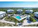 Aerial view of community pool area surrounded by lush greenery, offering a relaxing and luxurious atmosphere at 7470 Palm Island Dr # 2813, Placida, FL 33946
