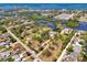 Stunning aerial view of waterfront property with lush landscaping and canal access to the bay at 760 S Oxford Dr, Englewood, FL 34223