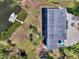 Aerial view shows dock and boat behind waterfront home, with patio and parking area at 760 S Oxford Dr, Englewood, FL 34223