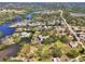 Wide aerial view of a serene community with houses nestled among trees and winding canals at 760 S Oxford Dr, Englewood, FL 34223