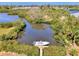 Aerial view of boat docked on a private wooden pier amidst mangrove trees and waterway at 760 S Oxford Dr, Englewood, FL 34223