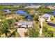 Stunning aerial view of a waterfront property with lush greenery and serene water features at 760 S Oxford Dr, Englewood, FL 34223