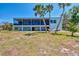 Expansive backyard featuring a cozy hammock and mature palm trees, perfect for relaxation at 760 S Oxford Dr, Englewood, FL 34223