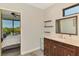Bathroom featuring a dark wood vanity, marble countertops, and open shelving at 760 S Oxford Dr, Englewood, FL 34223