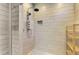 Modern walk-in shower is beautifully tiled and equipped with a rainfall showerhead and convenient built-in niche at 760 S Oxford Dr, Englewood, FL 34223