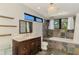 Charming bathroom with decorative chandelier, bathtub, and marble countertops at 760 S Oxford Dr, Englewood, FL 34223