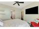 Bright bedroom with dark floors, accent lighting, ceiling fan, and ensuite bath at 760 S Oxford Dr, Englewood, FL 34223