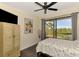 Comfortable bedroom featuring a sliding glass door that opens to a covered patio with beautiful outdoor views at 760 S Oxford Dr, Englewood, FL 34223