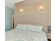 Well-lit bedroom with wood accent wall and light blue walls creates a relaxing and comfortable space at 760 S Oxford Dr, Englewood, FL 34223