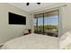 Bedroom with a large television and screened-in porch overlooking a waterfront view at 760 S Oxford Dr, Englewood, FL 34223