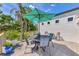 Outdoor deck with a green umbrella, dining area and decorative plants create an inviting outdoor living space at 760 S Oxford Dr, Englewood, FL 34223