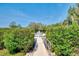Private dock surrounded by lush foliage offers direct access to the tranquil waterway at 760 S Oxford Dr, Englewood, FL 34223