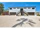 Unique two-story home with dual garages, an elevated walkway, and ample parking space at 760 S Oxford Dr, Englewood, FL 34223