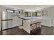 Modern kitchen with white cabinetry, stainless steel appliances, and a large center island with seating at 760 S Oxford Dr, Englewood, FL 34223