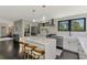 Modern kitchen with a large island, stainless steel appliances and dark hardwood floors throughout at 760 S Oxford Dr, Englewood, FL 34223