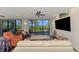 Bright living room with a ceiling fan, waterfront view, and sliding glass doors to a deck at 760 S Oxford Dr, Englewood, FL 34223
