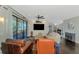 Open concept living room with modern decor, dark hardwood floors and access to the outdoor balcony at 760 S Oxford Dr, Englewood, FL 34223