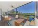 Spacious screened porch with comfortable seating, offering serene water views for relaxing outdoor living at 760 S Oxford Dr, Englewood, FL 34223