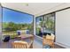 Inviting screened porch with comfortable seating, scenic water views, and access to the interior through sliding doors at 760 S Oxford Dr, Englewood, FL 34223