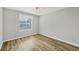 Bedroom with laminate flooring, ceiling fan, and window providing natural light and ventilation at 821 Montrose Dr # 201, Venice, FL 34293