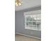 Bedroom featuring a neutral color palette, carpeted floor, and a window with blinds and a ceiling fan at 821 Montrose Dr # 201, Venice, FL 34293