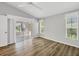 Bedroom with wood flooring, ceiling fan, and sliding glass doors to an outdoor patio space at 821 Montrose Dr # 201, Venice, FL 34293