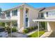 Charming two-story townhome with blue shutters, covered parking, and manicured landscaping at 821 Montrose Dr # 201, Venice, FL 34293