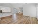 Spacious living room with modern flooring, chandelier and sight lines to the kitchen at 821 Montrose Dr # 201, Venice, FL 34293