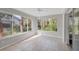 Sunroom with large windows overlooking lush foliage, creating a peaceful and inviting space at 821 Montrose Dr # 201, Venice, FL 34293