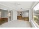 Open-concept sunroom with tiled flooring and views into other living spaces, enhancing connectivity at 821 Montrose Dr # 201, Venice, FL 34293