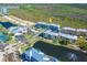 Aerial view showcasing a luxury condo community with a pool, tennis courts, and clubhouse at 8413 Placida Rd # 205, Placida, FL 33946