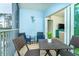 Cozy screened balcony with seating and a view of the living area at 8413 Placida Rd # 205, Placida, FL 33946