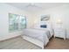 Cozy bedroom featuring a large window, neutral decor, and comfortable furnishings at 8413 Placida Rd # 205, Placida, FL 33946