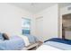 Bright bedroom with two twin beds, featuring light-colored linens and an open doorway at 8413 Placida Rd # 205, Placida, FL 33946