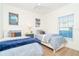 Charming bedroom featuring two twin beds with cozy blue linens and nautical-themed decor at 8413 Placida Rd # 205, Placida, FL 33946