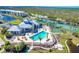 Community pool with lounge chairs, palm trees, tennis court and basketball court providing a relaxing oasis at 8413 Placida Rd # 205, Placida, FL 33946