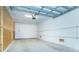 Spacious garage featuring a neutral color palette, a garage door opener and ample space for parking and storage at 8413 Placida Rd # 205, Placida, FL 33946