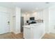 Well-lit kitchen featuring modern appliances, white cabinetry, and a breakfast bar at 8413 Placida Rd # 205, Placida, FL 33946