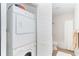 Convenient laundry area with stacked washer and dryer adjacent to a bathroom at 8413 Placida Rd # 205, Placida, FL 33946