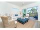 Bright living room with neutral tones, comfortable seating, and a balcony offering serene outdoor views at 8413 Placida Rd # 205, Placida, FL 33946